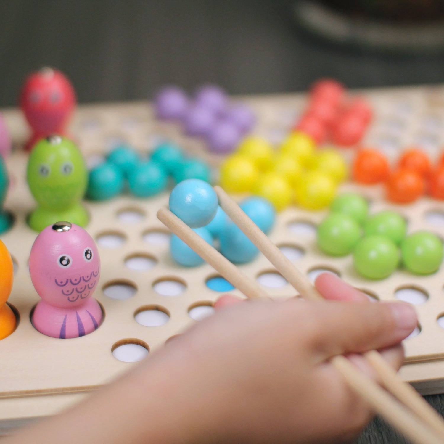 Improve motor skills with colourful wooden balls sorting game, a fun and educational experience