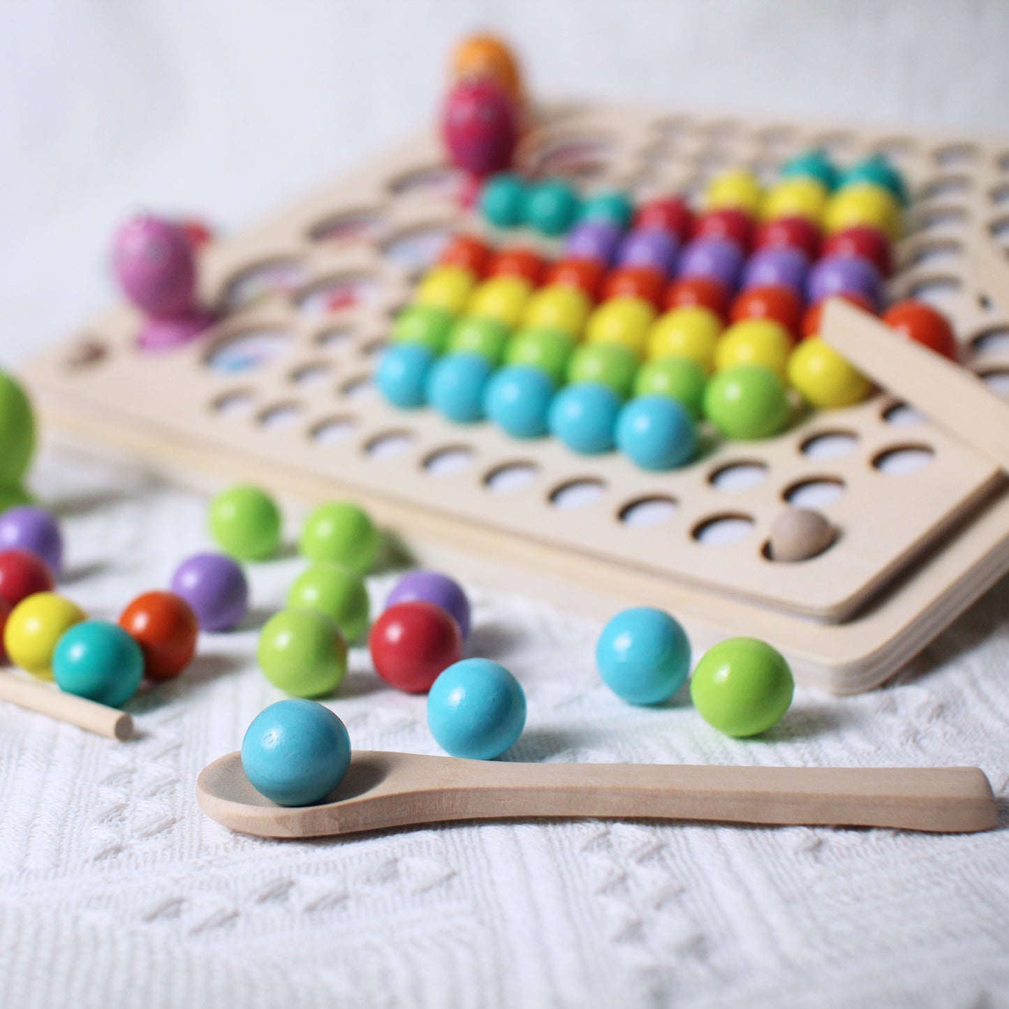 creating picture with colourful wooden balls sorting game and colourful wooden fishes fishing memory game, chopsticks, thong, spoon, fishing rod and silicone cups provided for fun and educational experience